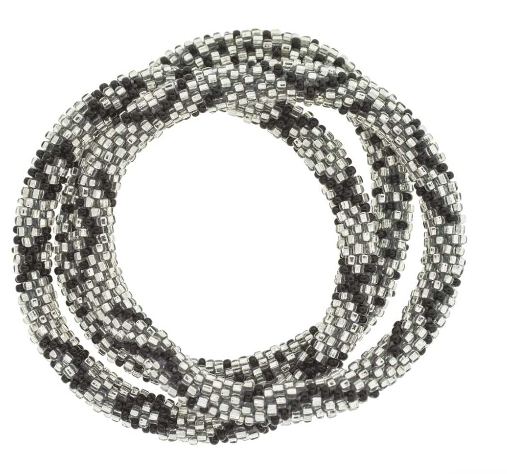 Aid Through Trade roll-on beaded bracelets in black and silver glass beads, stacked in a coil