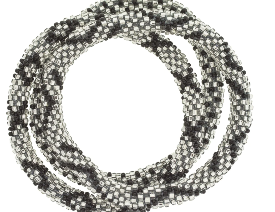 Aid Through Trade roll-on beaded bracelets in black and silver glass beads, stacked in a coil