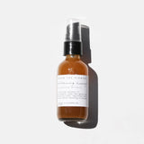 Among the Flowers Balancing Honey Cleanser, amber glass pump bottle with a white label on white