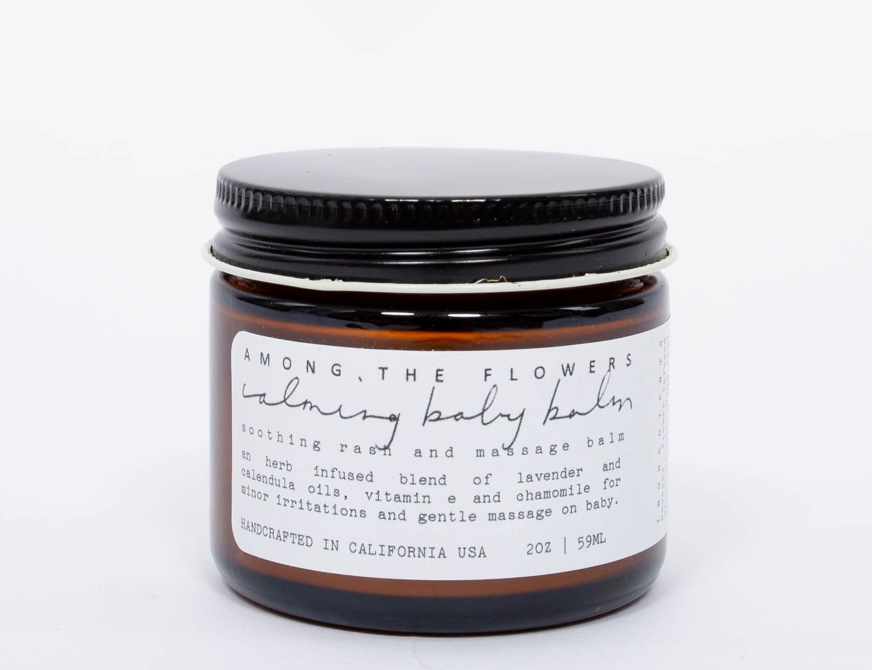 Among the Flowers Calming Baby Balm in an amber glass jar with a black lid and white label