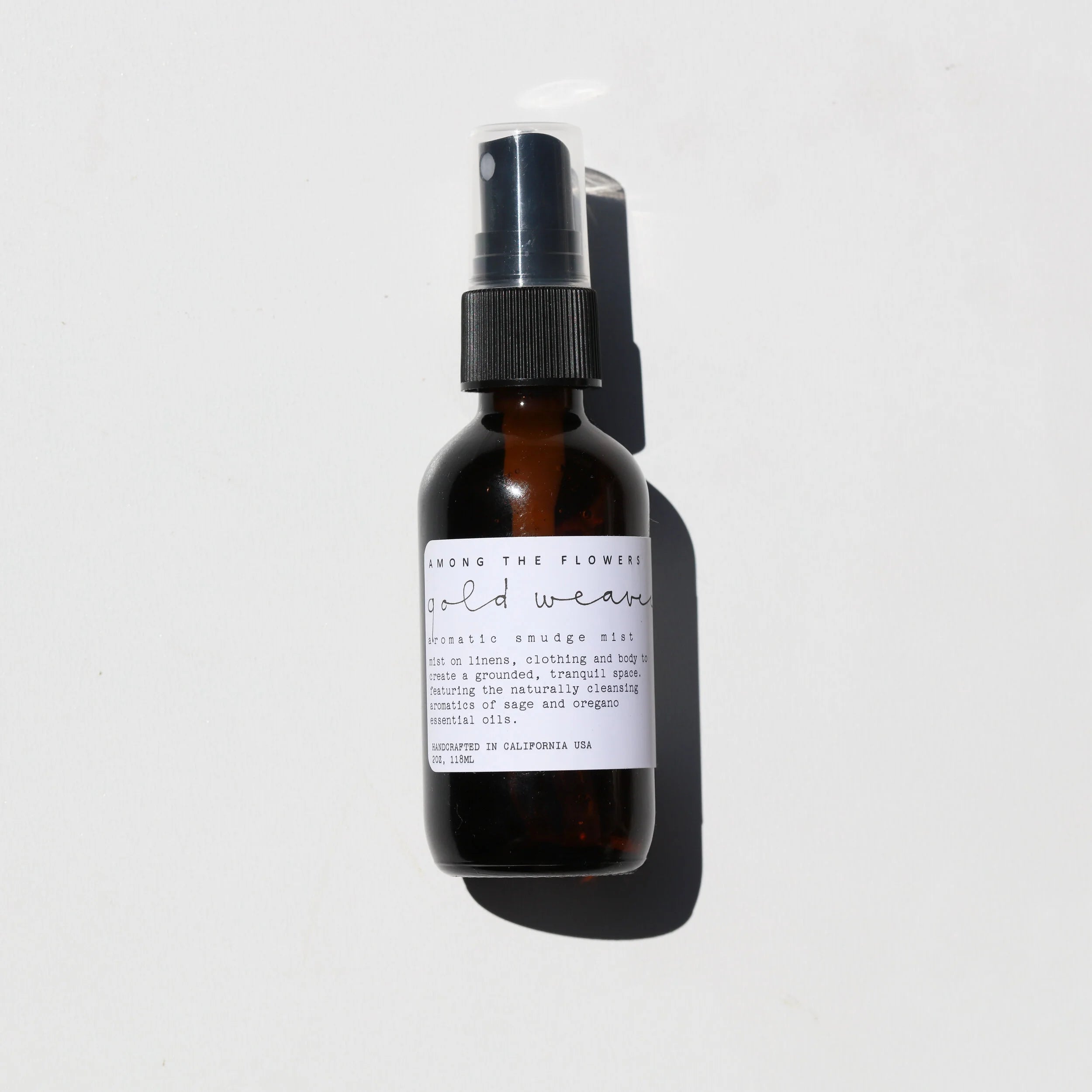 Among the Flowers Gold Weaver Aromatic Smudge Mist in an amber glass spray bottle