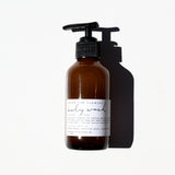Among the Flowers Lavender Lullaby Baby Wash in an amber pump bottle