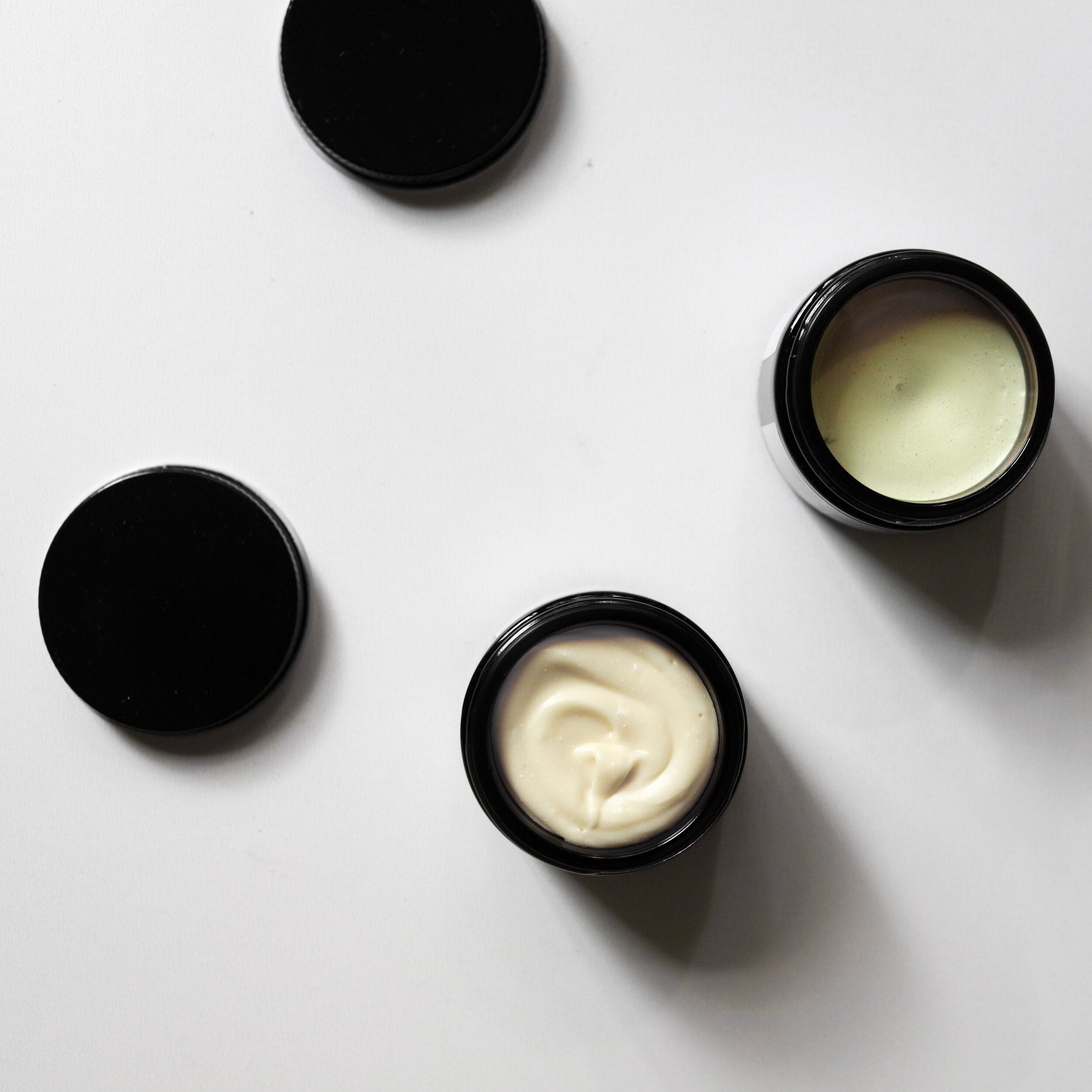 Among the Flowers New Mom + Babe Kit black jars of balm open showing the pale yellow contents