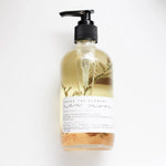 Among the Flowers New Moon Meditation Oil in a clear pump bottle with botanicals inside