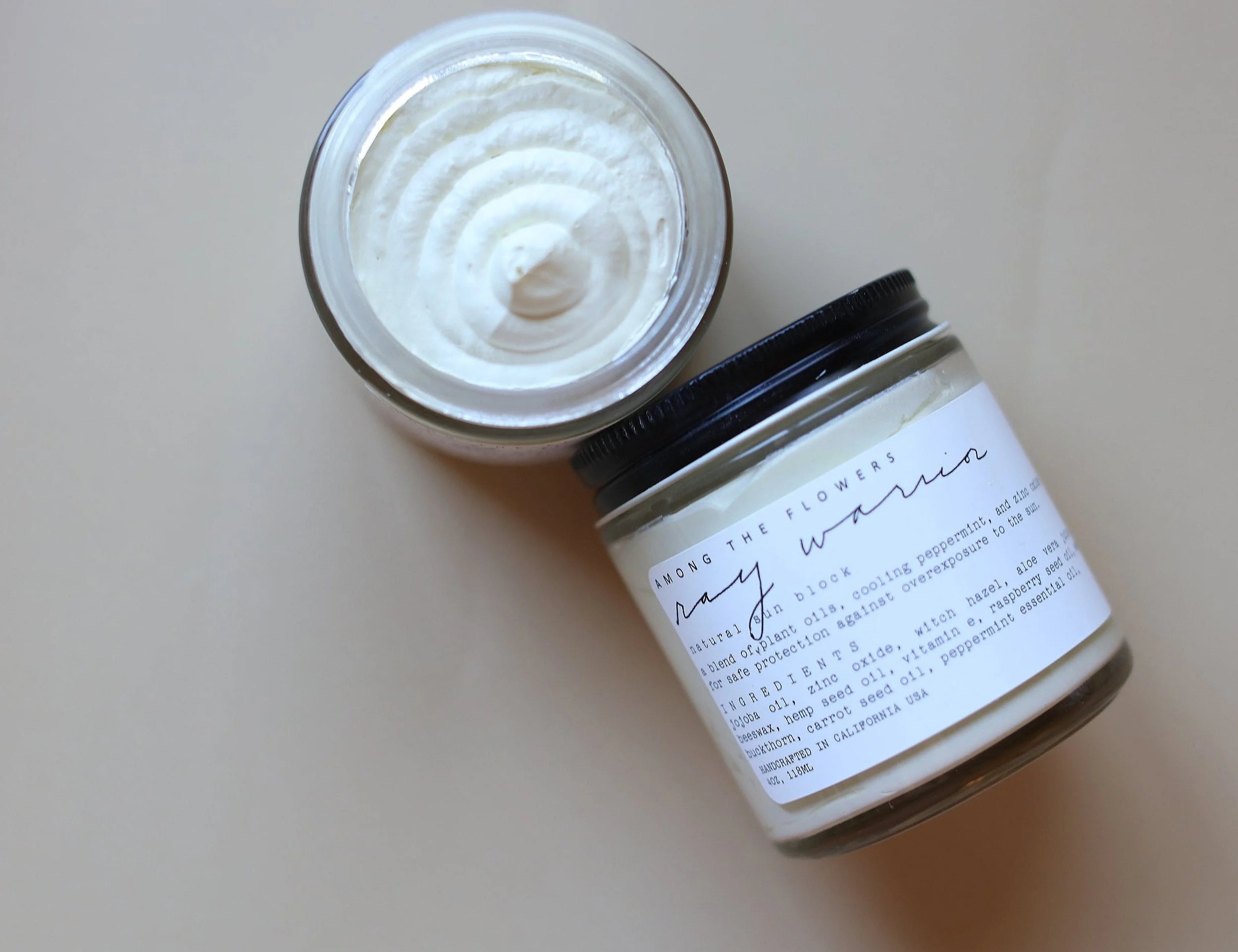 Among the Flowers Ray Warrior Natural UV Shield open jar showing the white cream, from above