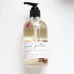 Among the Flowers Rose Petal Meditation Oil in a clear pump bottle with rose petals inside