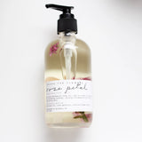 Among the Flowers Rose Petal Meditation Oil in a clear pump bottle with rose petals inside