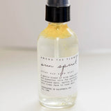 Close-up of the Among the Flowers Sun Spirit Cooling Aloe Mist label on the clear bottle