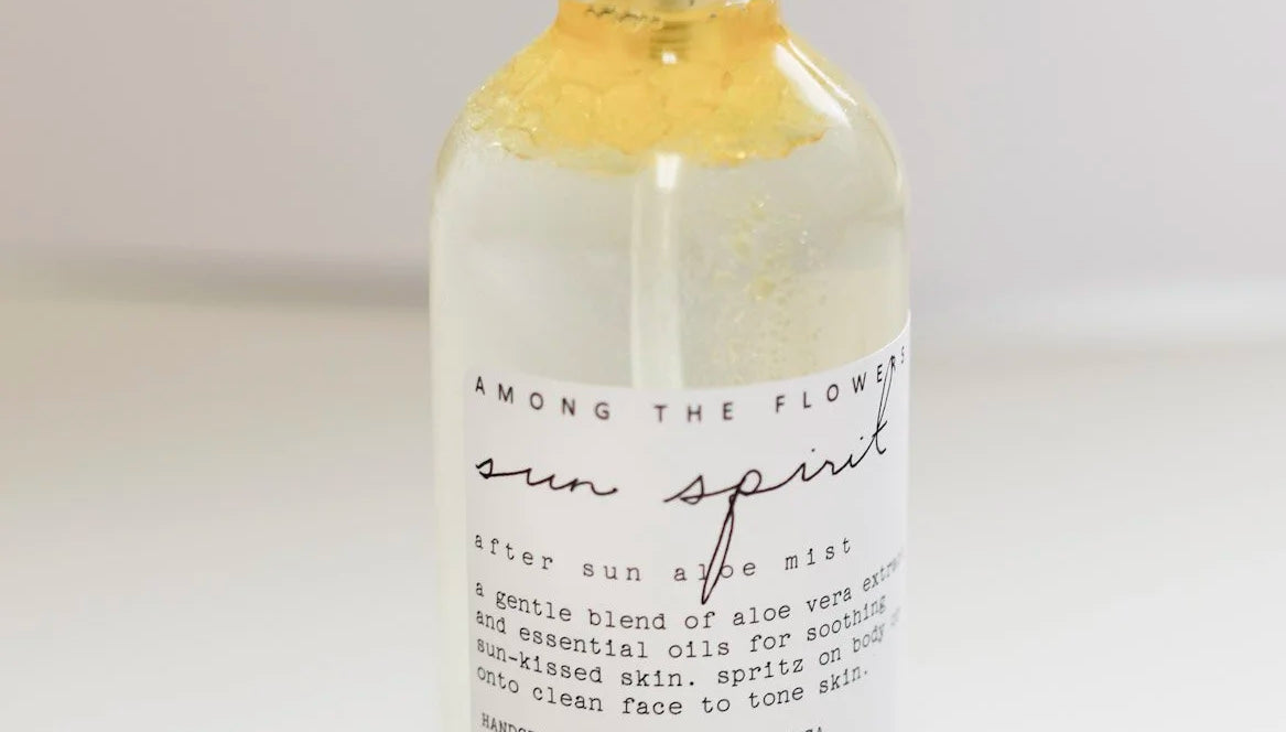 Close-up of the Among the Flowers Sun Spirit Cooling Aloe Mist label on the clear bottle
