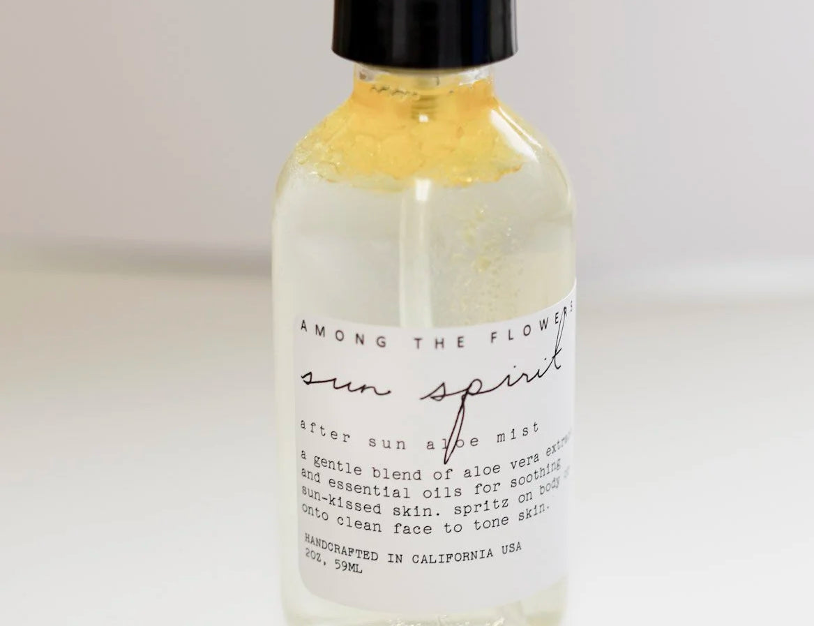 Close-up of the Among the Flowers Sun Spirit Cooling Aloe Mist label on the clear bottle