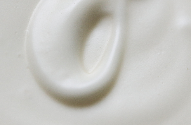Close-up swirl of white Among the Flowers Tallow Body Cream showing its whipped texture