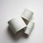 Among the Flowers Tallow Face Cream jars in white cylinder packaging grouped together