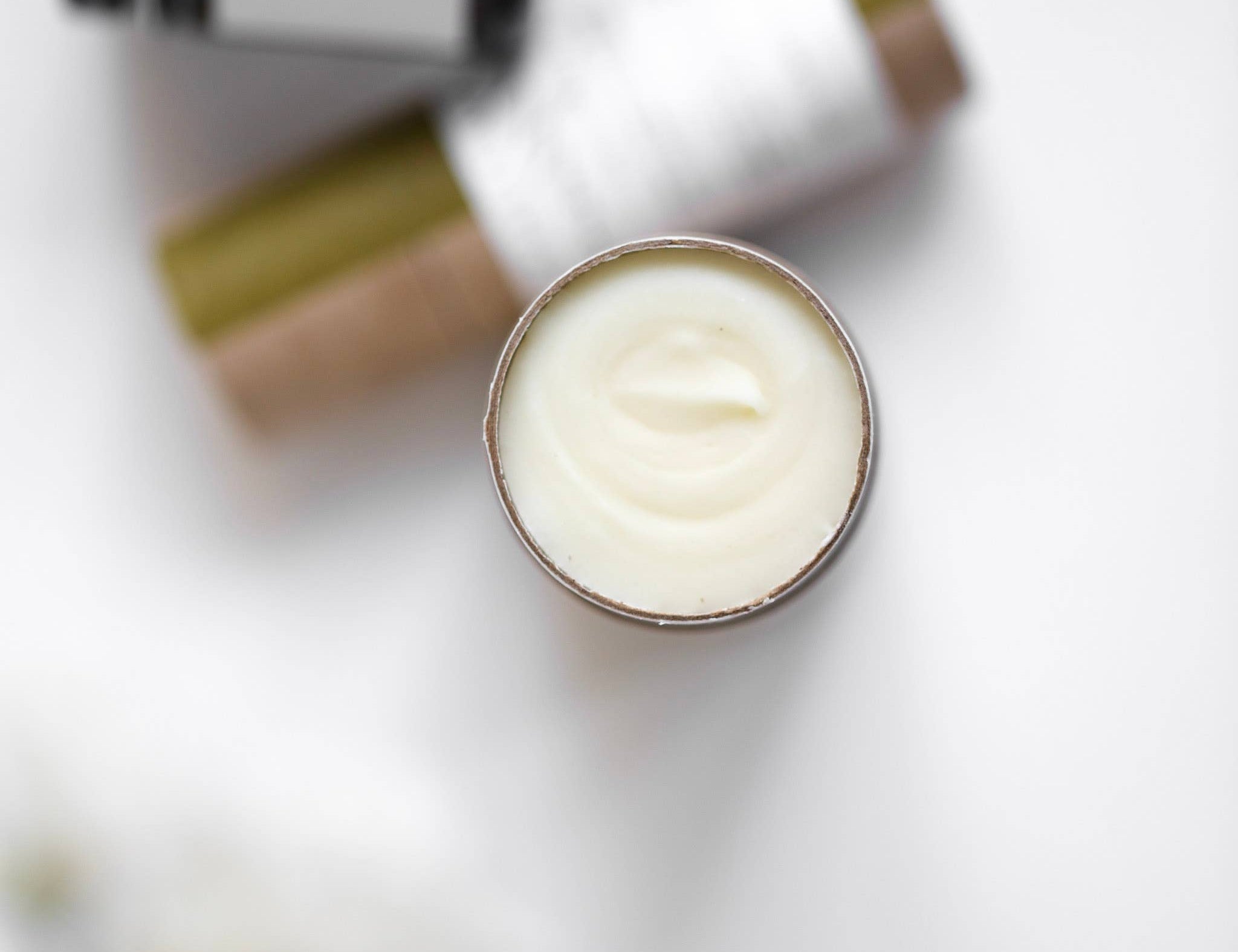 Among the Flowers Wildflower Natural Deodorant, open cream tube showing the white deodorant, close-up