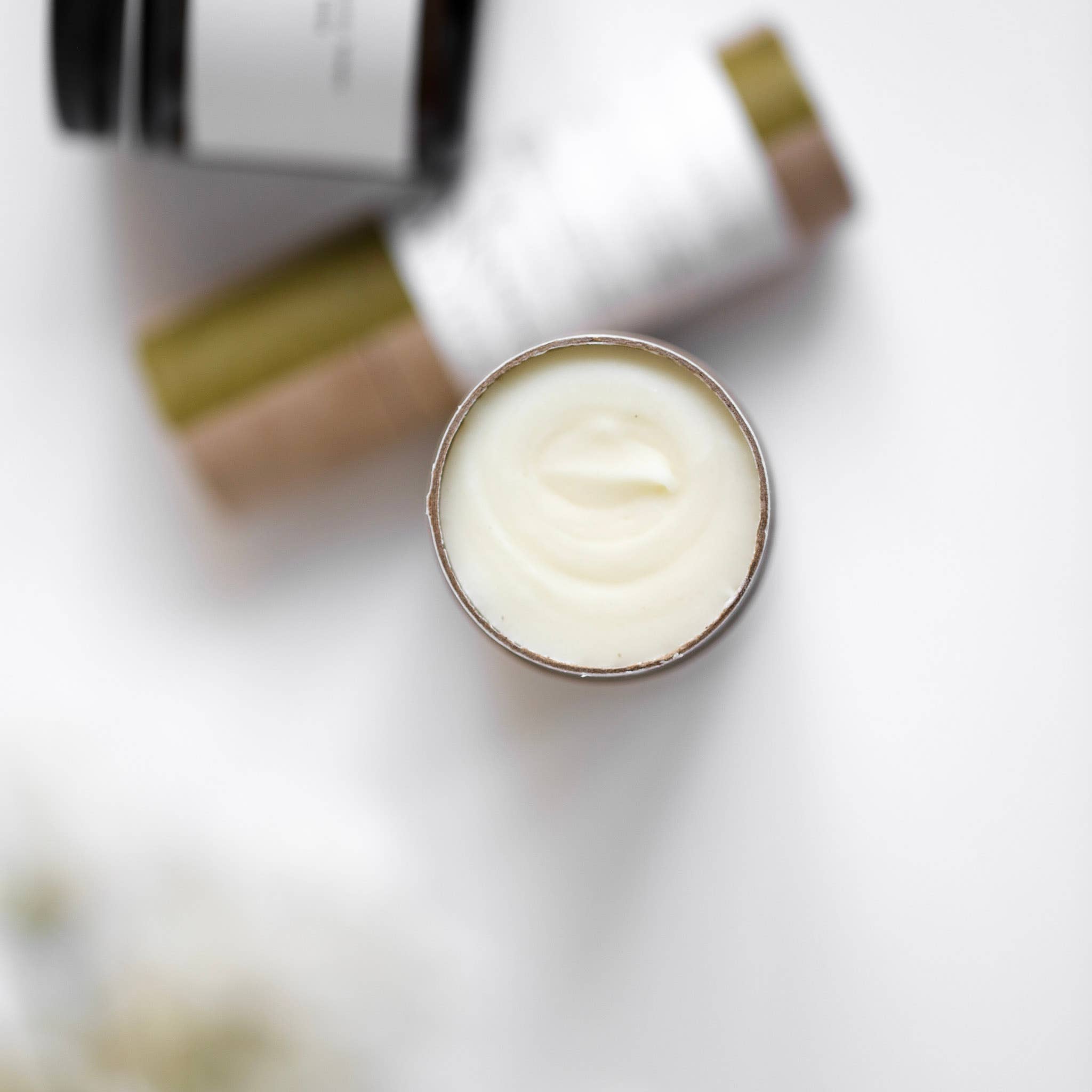 Among the Flowers Wildflower Natural Deodorant, open cream tube showing the white deodorant, close-up