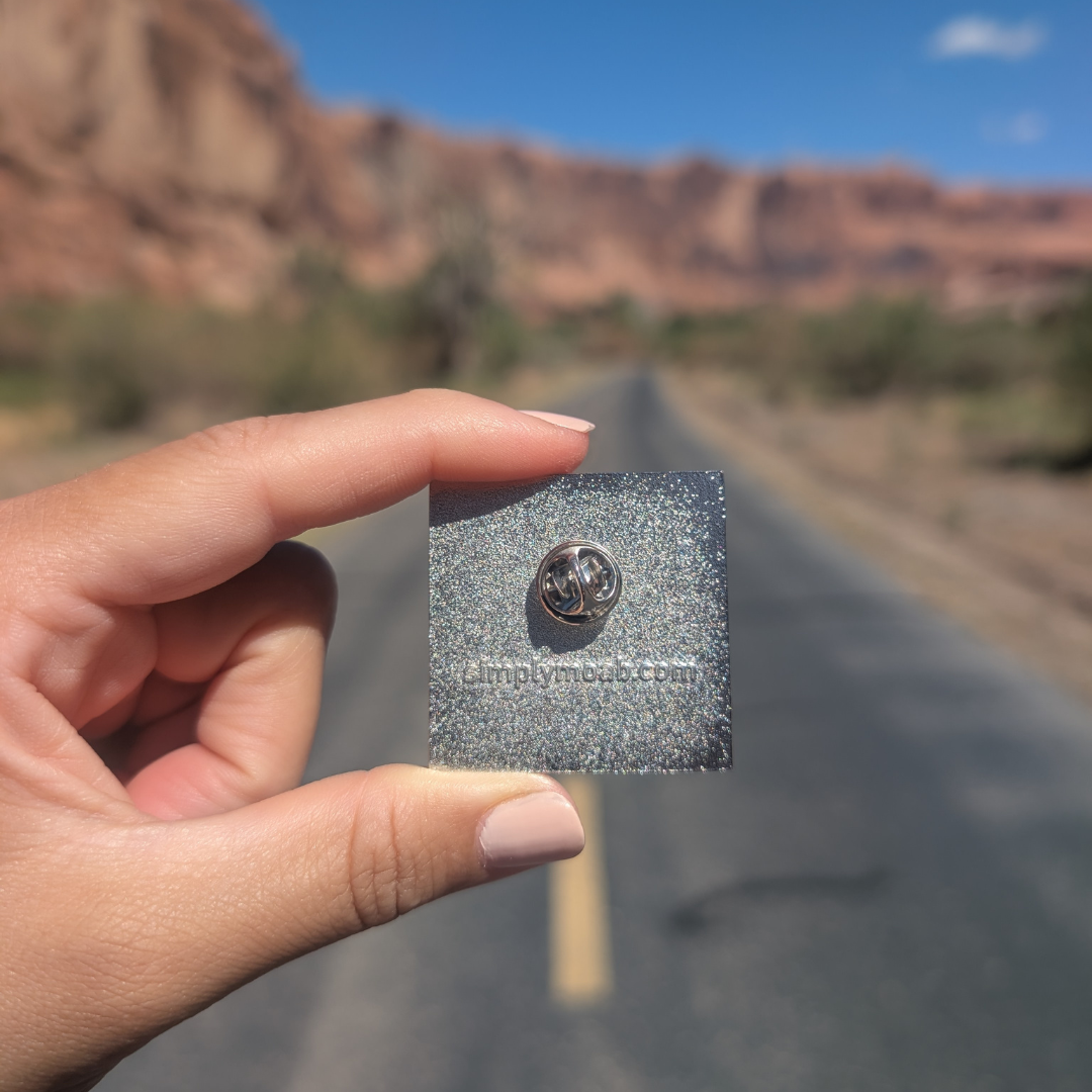 Back of the Arches National Park pink sky enamel pin showing the rubber clutch.