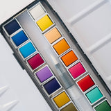Bailey Rae Studio 24 Color Watercolor Paint Palette, close-up of bright yellow, orange, red, pink and blue watercolor pans with the water brush