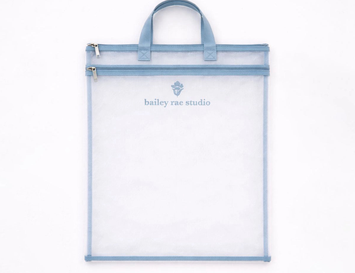Bailey Rae Studio Carry-All Bag, a clear zip pouch with light blue trim and handles