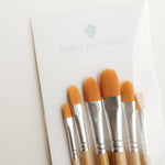 Close-up of the orange filbert brush heads on the Bailey Rae Studio Watercolor Brush Set of 6