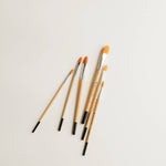 Bailey Rae Studio Filbert Watercolor Brushes laid loosely on a white surface