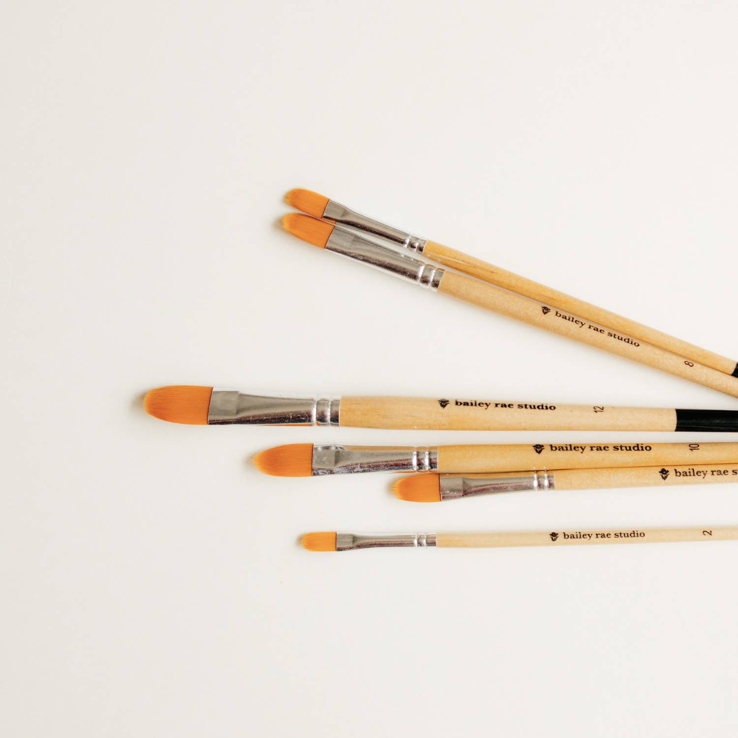 Bailey Rae Studio Filbert Watercolor Brushes arranged in a row showing the graduated sizes