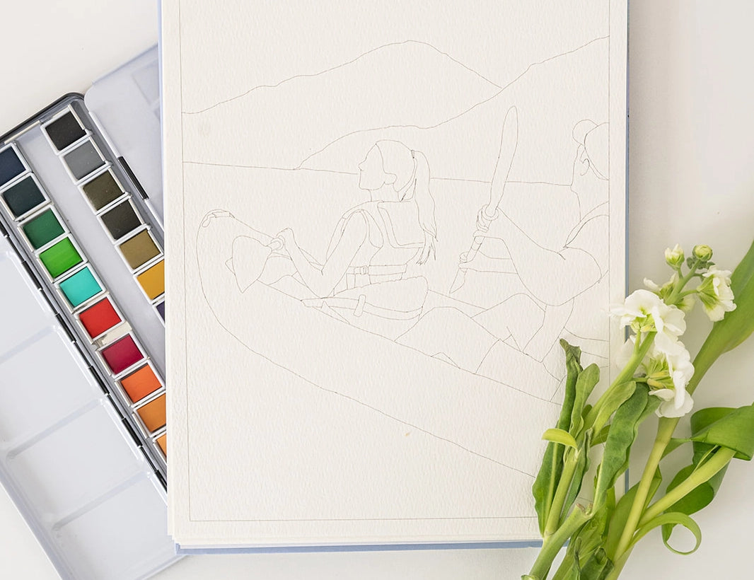 Bailey Rae Studio Landscape Watercoloring Book open to a mountain outline with a paint palette and flowers