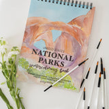 Bailey Rae Studio National Parks Watercoloring Book with brushes and white flowers
