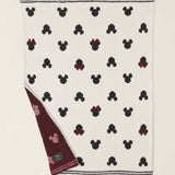 Barefoot Dreams Classic Disney Baby Blanket with a corner turned up to show the burgundy reverse side