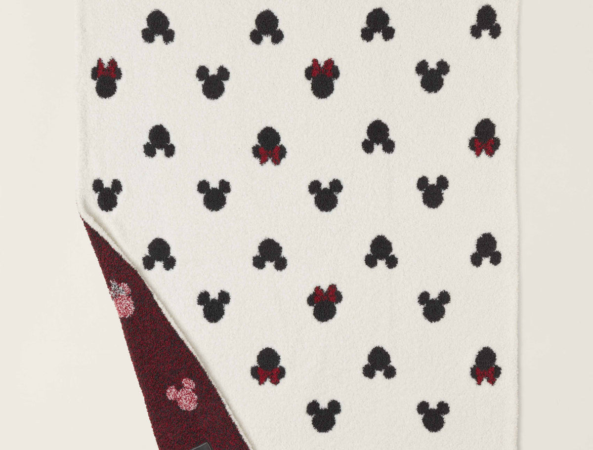 Barefoot Dreams Classic Disney Baby Blanket with a corner turned up to show the burgundy reverse side