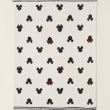 Barefoot Dreams Classic Disney Baby Blanket, a cream blanket with black Mickey and red-bow Minnie icons