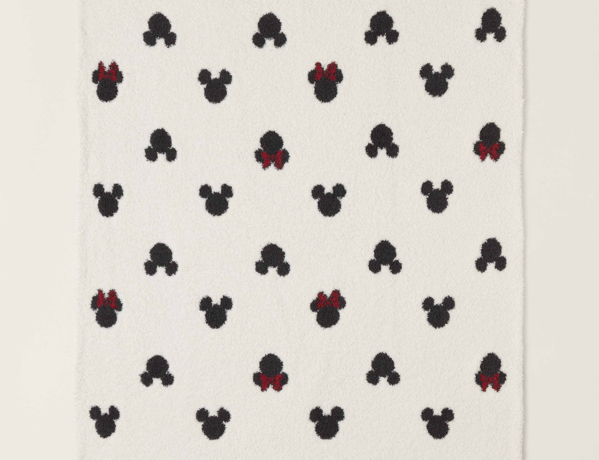 Barefoot Dreams Classic Disney Baby Blanket, a cream blanket with black Mickey and red-bow Minnie icons