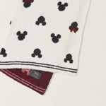 Barefoot Dreams Classic Disney Baby Blanket draped to show the Mickey print and burgundy underside
