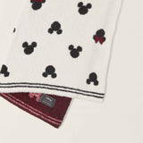 Barefoot Dreams Classic Disney Baby Blanket draped to show the Mickey print and burgundy underside