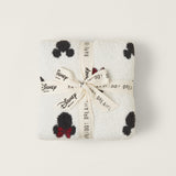 Barefoot Dreams Classic Disney Baby Blanket folded and tied with a Disney and Barefoot Dreams ribbon
