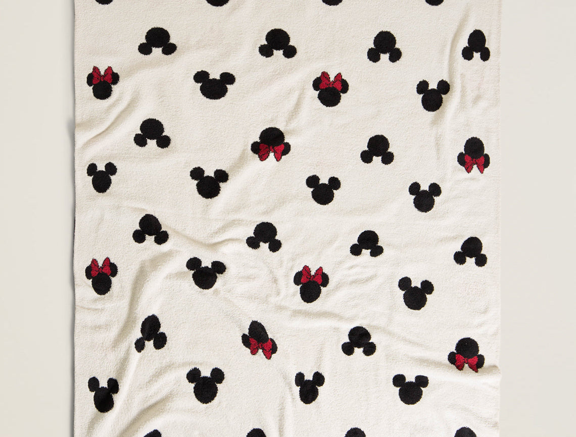 Barefoot Dreams Classic Disney Baby Blanket laid loosely with the Mickey and Minnie print