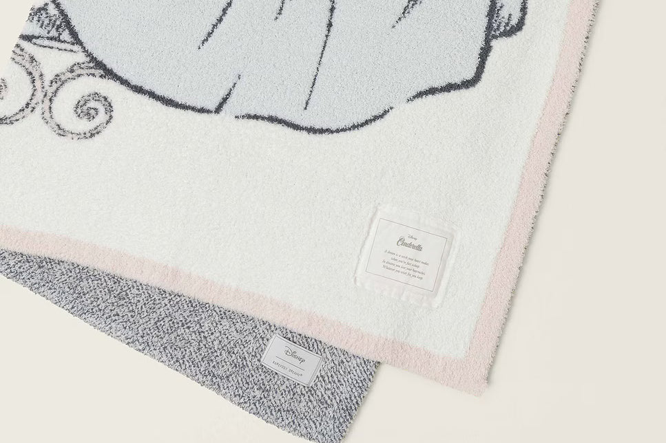 Close-up of the Cinderella gown knit detail and pink edge on the Barefoot Dreams Cozy Disney Princess Blanket