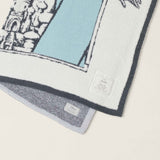 Close-up of the teal and navy knit detail and gray reverse on the Barefoot Dreams Cozy Disney Princess Blanket in Jasmine