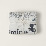Barefoot Dreams Cozy Disney Princess Blanket in Jasmine folded and tied with a Disney ribbon