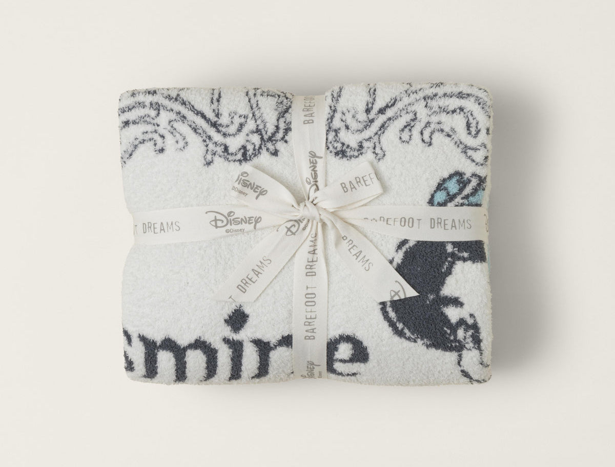 Barefoot Dreams Cozy Disney Princess Blanket in Jasmine folded and tied with a Disney ribbon