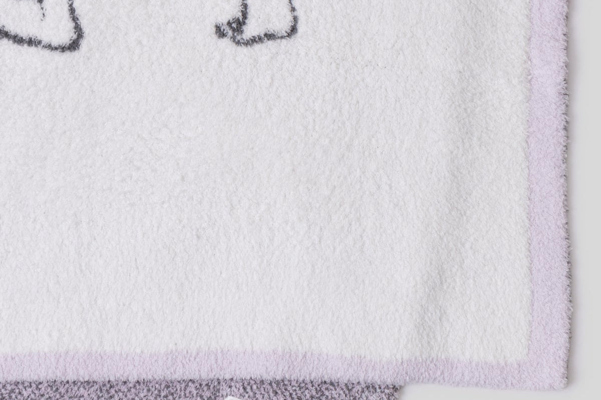 Close-up of the lavender knit and purple edge on the Barefoot Dreams Cozy Disney Princess Blanket in Rapunzel
