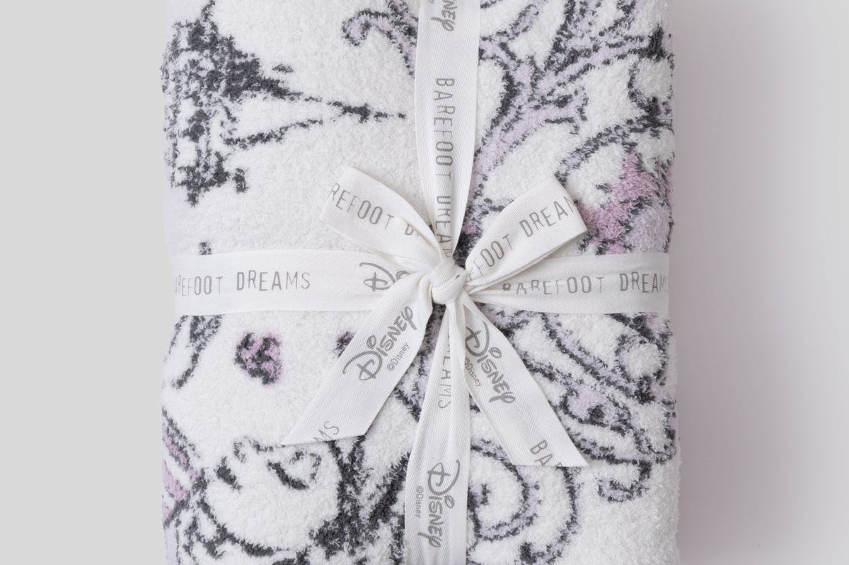 Barefoot Dreams Cozy Disney Princess Blanket in Rapunzel folded and tied with a Disney ribbon