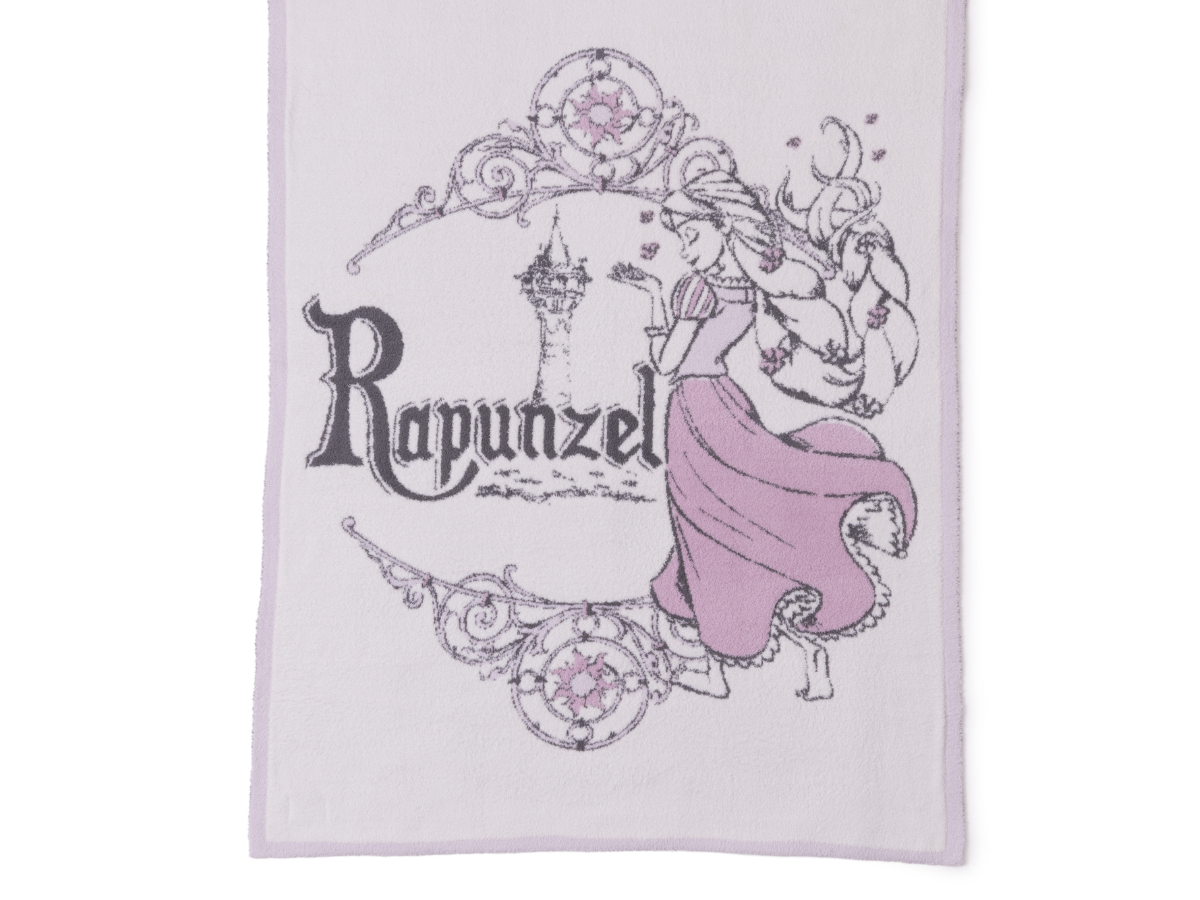 Barefoot Dreams Cozy Disney Princess Blanket in Rapunzel, a lavender knit blanket with a Rapunzel design