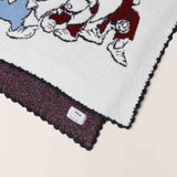 Close-up of the scalloped edge and burgundy reverse on the Barefoot Dreams Cozy Disney Princess Blanket in Snow White