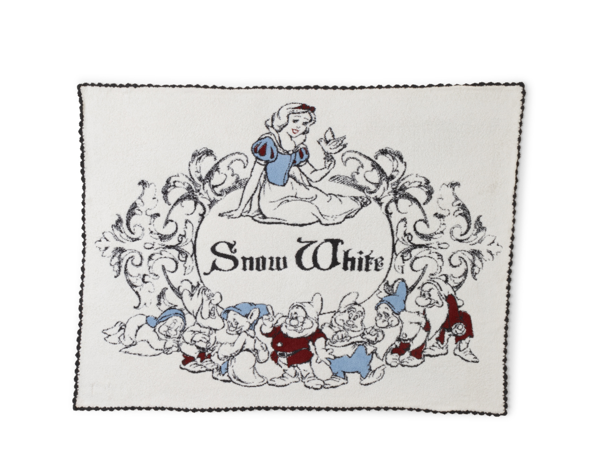 Barefoot Dreams Cozy Disney Princess Blanket in Snow White, a cream knit blanket with Snow White and the seven dwarfs