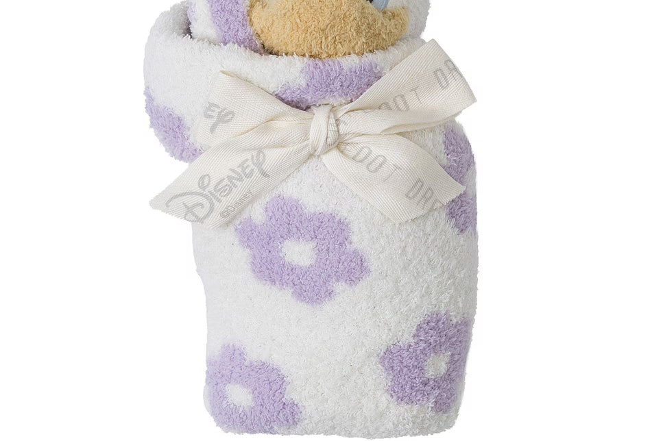 Barefoot Dreams Disney Blanket Buddie in Daisy Duck rolled and tied with a ribbon