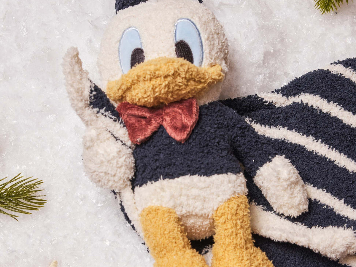 Barefoot Dreams Disney Blanket Buddie in Donald Duck, plush Donald on a navy striped lovey blanket