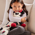 Smiling girl hugging a Barefoot Dreams Disney Blanket Buddie in Minnie Mouse