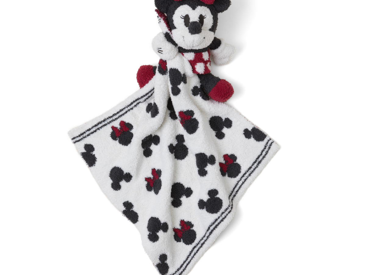 Barefoot Dreams Disney Blanket Buddie in Minnie Mouse, a knit Minnie plush on a Mickey-print lovey blanket