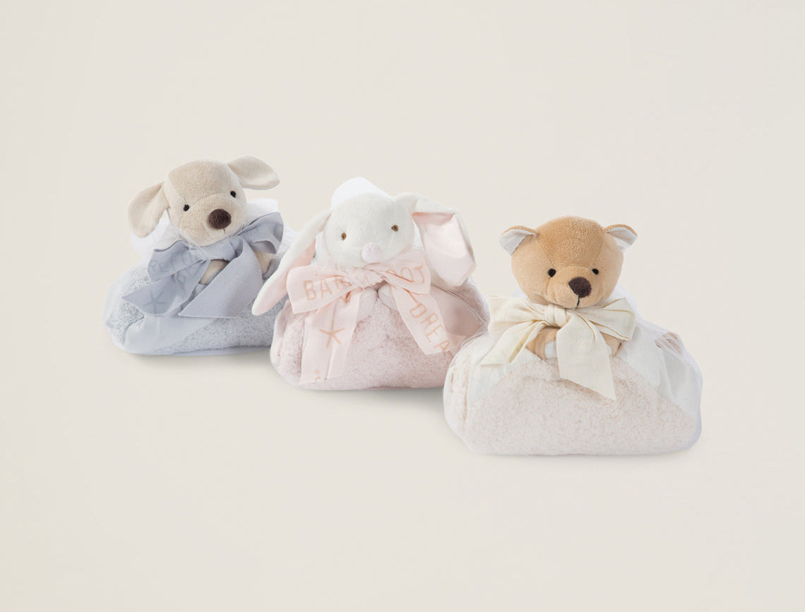Barefoot Dreams Disney Blanket Buddies in Blue Puppy, Pink Bunny and tan bear folded side by side