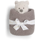 Barefoot Dreams Disney Blanket Buddie in Winnie the Pooh rolled in a taupe blanket and tied with a ribbon