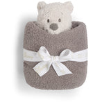 Barefoot Dreams Disney Blanket Buddie in Winnie the Pooh rolled in a taupe blanket and tied with a ribbon